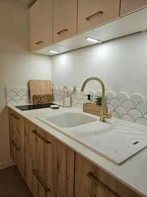 a kitchen with a sink and a counter top at LE JACQUARD Appartement Type 2 proche des Halles in Narbonne