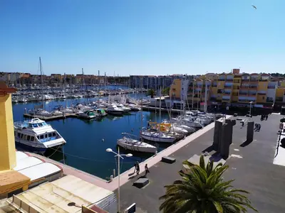 a marina with boats docked in a harbor at Côté port in Gruissan