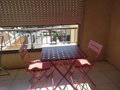 a table and two chairs on a balcony at Côté port in Gruissan
