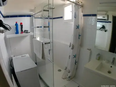 a bathroom with a shower and a toilet and a sink at Côté port in Gruissan