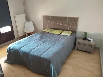 a bedroom with a large blue bed with yellow pillows at Côté port in Gruissan