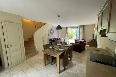 a living room with a table and a couch at Maison Kokopetit - Dans les Corbières in Saint-Laurent-de-la-Cabrerisse