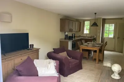 a living room with a couch and a tv at Maison Kokopetit - Dans les Corbières in Saint-Laurent-de-la-Cabrerisse