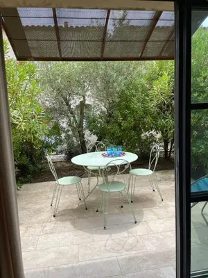 a table and chairs sitting on a patio at Maison Kokopetit - Dans les Corbières in Saint-Laurent-de-la-Cabrerisse
