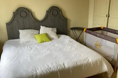a bed with a green pillow on top of it at Maison Kokopetit - Dans les Corbières in Saint-Laurent-de-la-Cabrerisse