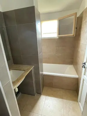 a bathroom with a bath tub and a sink at Maison Kokopetit - Dans les Corbières in Saint-Laurent-de-la-Cabrerisse
