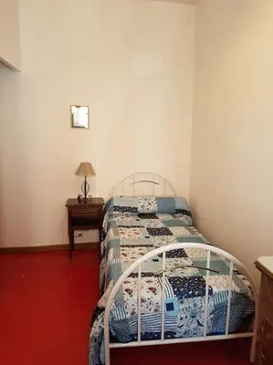 a bedroom with a bed and a table with a lamp at Sigean - Maison domaine viticole, 6 km de la mer in Sigean