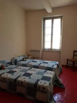 two beds in a room with a window at Sigean - Maison domaine viticole, 6 km de la mer in Sigean