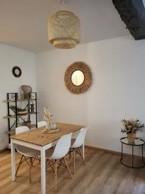 a dining room with a wooden table and chairs at Maison de village à la décoration bohème jusqu'à 6 personnes in Viviers-lès-Montagnes