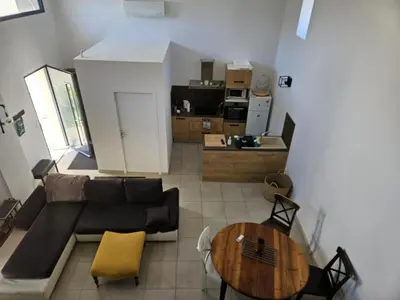 a living room with a couch and a table at La Bergerie in Narbonne