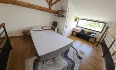 a bedroom with a large bed in a room at La Bergerie in Narbonne