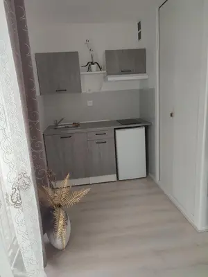 a kitchen with a sink and a counter top at studio avec piscine in Gruissan