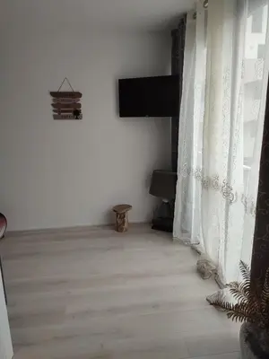 a white room with a television and a window at studio avec piscine in Gruissan