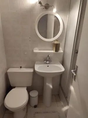 a bathroom with a toilet and a sink and a mirror at studio avec piscine in Gruissan