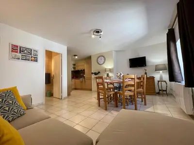 a living room and dining room with a table and chairs at Le Verdun N°38 - 70m2 - Carcassonne hyper-centre in Carcassonne