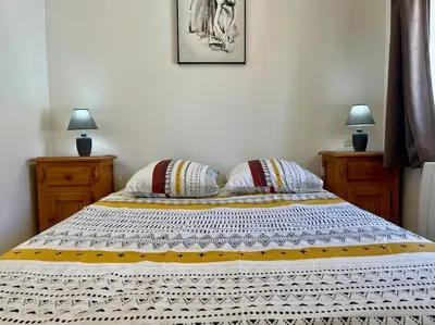 a bedroom with a bed with two night stands and two lamps at Le Verdun N°38 - 70m2 - Carcassonne hyper-centre in Carcassonne