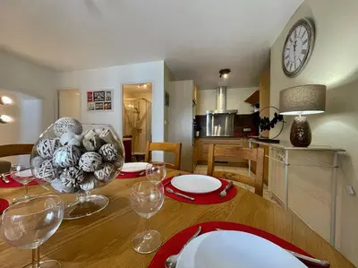 a dining room table with wine glasses and a clock on the wall at Le Verdun N°38 - 70m2 - Carcassonne hyper-centre in Carcassonne