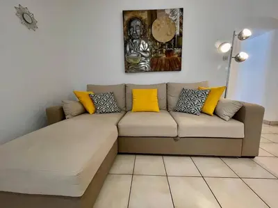 a couch in a living room with yellow pillows at Le Verdun N°38 - 70m2 - Carcassonne hyper-centre in Carcassonne