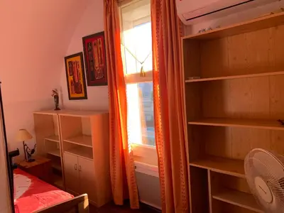 a room with shelves and a window and a bed at GRUISSAN PORT JOLI T3 DUPLEX in Gruissan