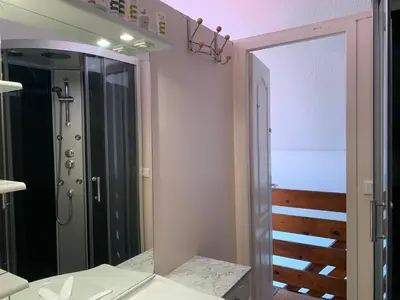 a bathroom with a mirror and a walk in shower at GRUISSAN PORT JOLI T3 DUPLEX in Gruissan