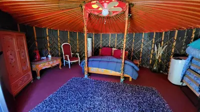 a bedroom with a bed in a tent at La Yourte in Vinassan