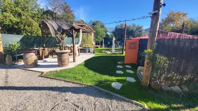 a garden with a fence and a gazebo at La Yourte in Vinassan