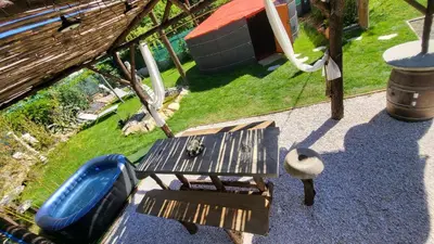 an overhead view of a park with a picnic table and a playground at La Yourte in Vinassan