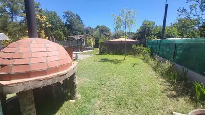 a yard with a brick building and a fence at La Yourte in Vinassan