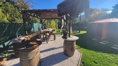 a pergola with a picnic table and a bench at La Yourte in Vinassan