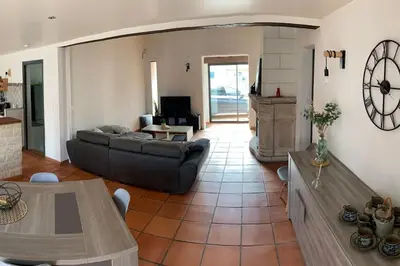 a living room with a couch and a table at Jolie Villa piscine à 15 min du Barcarès in Salses-le-Chateau
