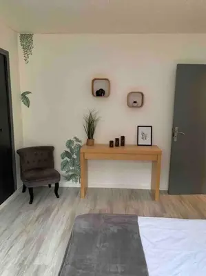 a bedroom with a table and a chair and a desk at Jolie Villa piscine à 15 min du Barcarès in Salses-le-Chateau