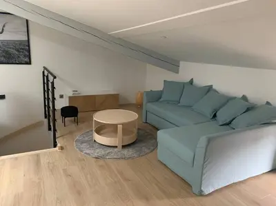 a living room with a blue couch and a table at Magnifique appartement T2 en Centre VILLAGE in Saverdun