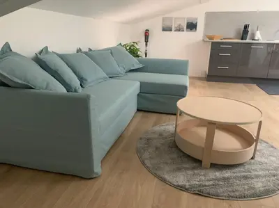 a living room with a blue couch and a table at Magnifique appartement T2 en Centre VILLAGE in Saverdun