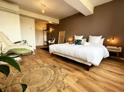 a large bedroom with a large white bed in it at O'mA Style in Carcassonne