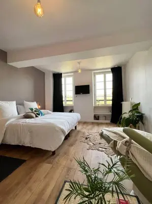 a bedroom with two beds and a television in it at O'mA Style in Carcassonne