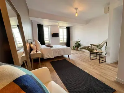 a bedroom with a bed and a living room at O'mA Style in Carcassonne