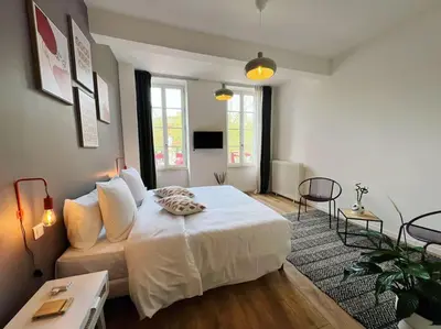 a bedroom with a white bed and a couch at O'mA View in Carcassonne