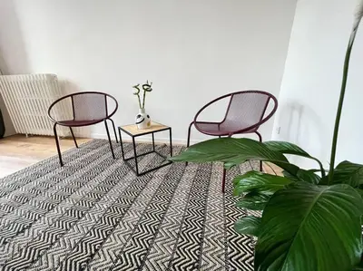 two chairs and a table in a room with a plant at O'mA View in Carcassonne
