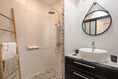 a bathroom with a sink and a mirror at La Cave... entre Narbonne et Carcassonne in Conilhac-Corbières