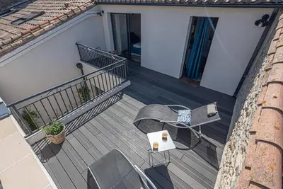 an overhead view of a balcony with a table and chairs at La Cave... entre Narbonne et Carcassonne in Conilhac-Corbières