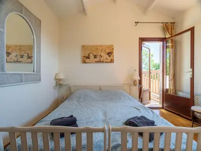 a bedroom with a bed and a window at Beautiful domaine with private pool and park in Cazouls-lès-Béziers