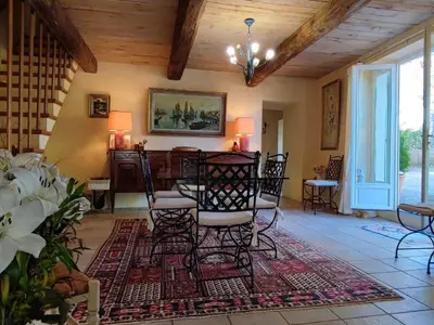 a living room with chairs and a table in it at Beautiful domaine with private pool and park in Cazouls-lès-Béziers