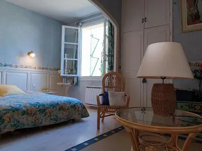 a bedroom with a bed and a glass table at Beautiful domaine with private pool and park in Cazouls-lès-Béziers