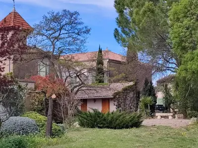 an exterior view of a house with a tower at Beautiful domaine with private pool and park in Cazouls-lès-Béziers