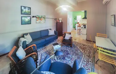 a living room with a blue couch and a rug at Nice Home In Saint-Chinian With Wifi in Saint-Chinian