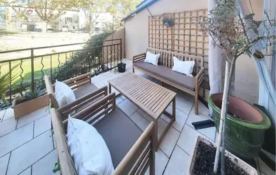 a balcony with two benches and a table and a tree at Nice Home In Saint-Chinian With Wifi in Saint-Chinian
