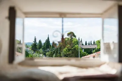 a window with a view of a city at Maison de la Roche in Ferrals-lès-Corbières