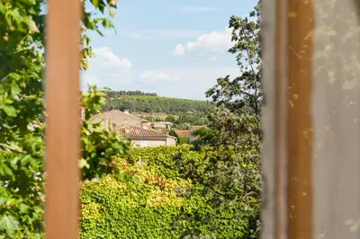 a view of a village from a window at Maison de la Roche in Ferrals-lès-Corbières