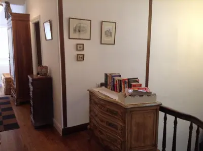 a room with a wooden dresser with books on it at La Maison de la Riviere B&B in Espéraza
