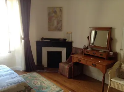 a living room with a mirror and a fireplace at La Maison de la Riviere B&B in Espéraza